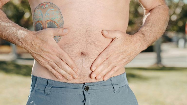 Person with their hands on their stomach